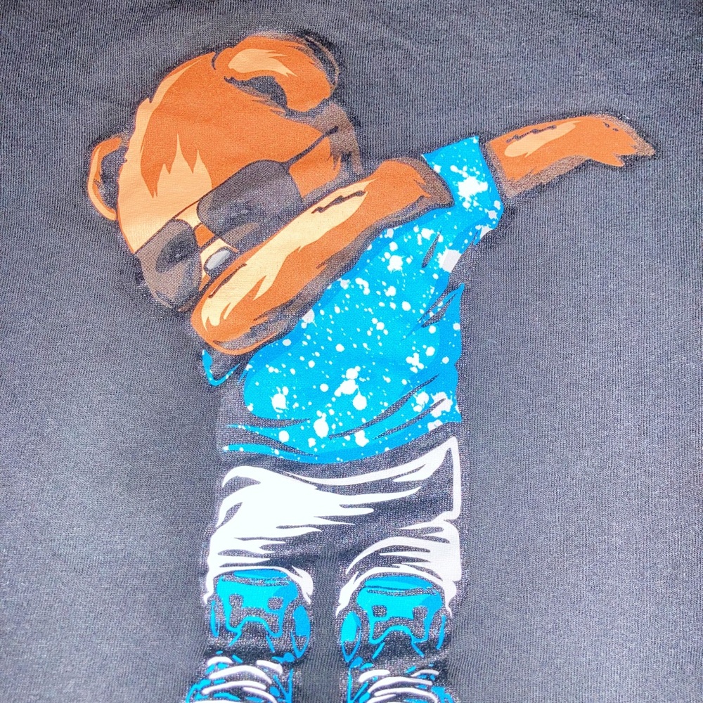 This stylish black shirt features an bear dabbing adding a playful touch.